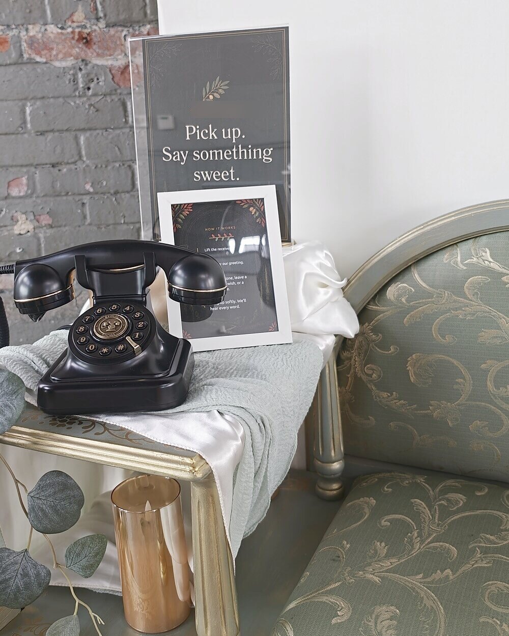 Vintage audio guestbook phone on a rust and sage table with a Pick up, say something sweet sign and candles